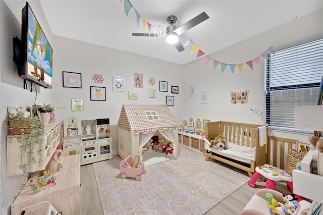25009 SW 108th Ave, Homestead, FL 33032 - bedroom featuring wood finished floors, a nursery area, and a ceiling fan