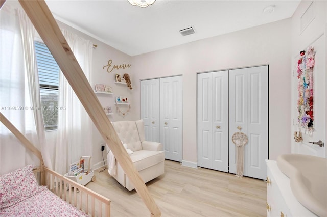 25009 SW 108th Ave, Homestead, FL 33032 - bedroom featuring two closets and light wood-style flooring