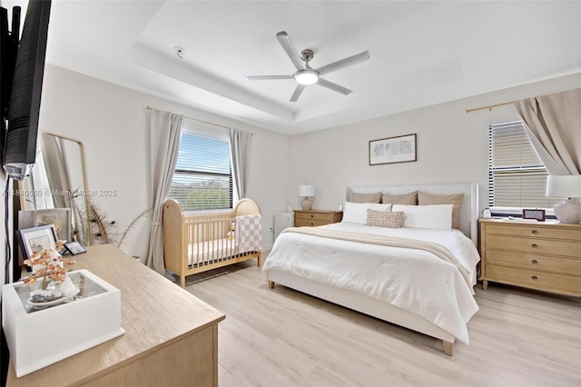 25009 SW 108th Ave, Homestead, FL 33032 - bedroom featuring light wood-style flooring, a raised ceiling, and ceiling fan