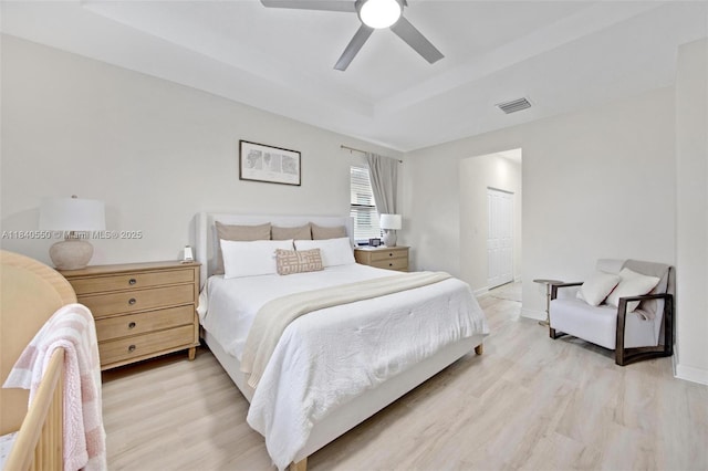 25009 SW 108th Ave, Homestead, FL 33032 - bedroom with a tray ceiling, light wood-type flooring, a ceiling fan, and a closet