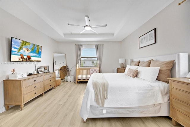 25009 SW 108th Ave, Homestead, FL 33032 - bedroom featuring a raised ceiling, light wood-style flooring, a ceiling fan, and radiator heating unit