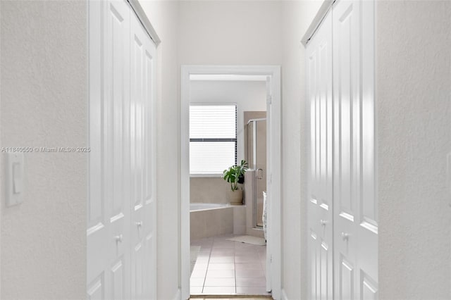 25009 SW 108th Ave, Homestead, FL 33032 - hallway featuring tile patterned flooring and a textured wall