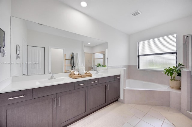 25009 SW 108th Ave, Homestead, FL 33032 - full bathroom featuring double vanity, tile patterned flooring, a garden tub, and a shower stall