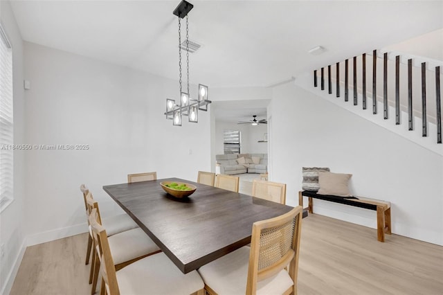 25009 SW 108th Ave, Homestead, FL 33032 - dining room with light wood-style flooring, a chandelier, and a ceiling fan