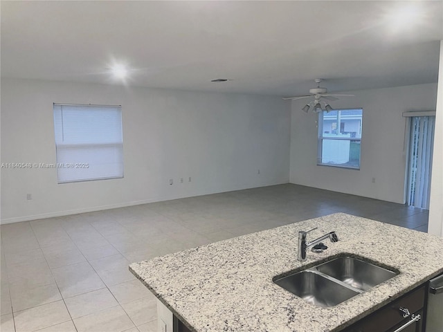 982 SW Alcantarra Blvd, Port St Lucie, FL 34953 - kitchen featuring open floor plan, a ceiling fan, light stone counters, and light tile patterned floors