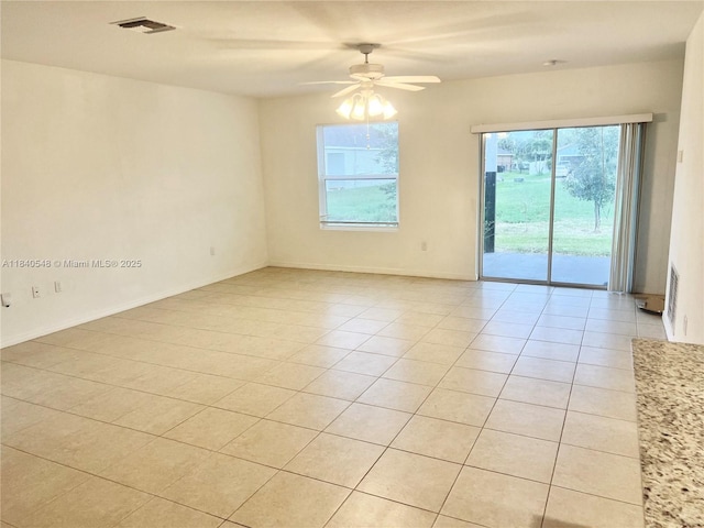 982 SW Alcantarra Blvd, Port St Lucie, FL 34953 - empty room featuring light tile patterned floors, healthy amount of natural light, and a ceiling fan