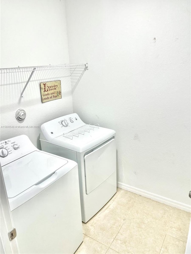 982 SW Alcantarra Blvd, Port St Lucie, FL 34953 - laundry room featuring washer and dryer and light tile patterned flooring