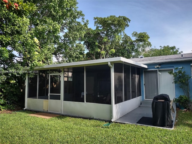 2506 Mayo St, Hollywood, FL 33020 - rear view of property with a sunroom and a yard