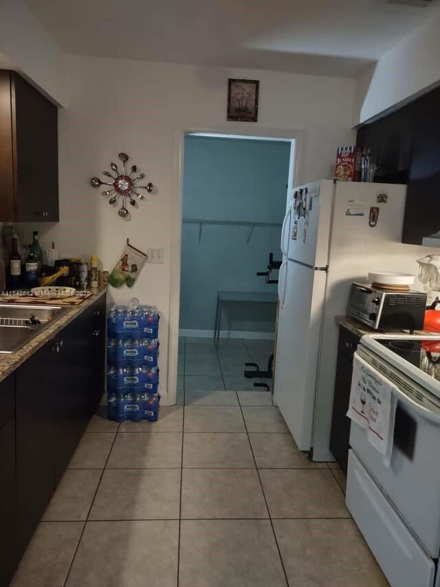 2506 Mayo St, Hollywood, FL 33020 - kitchen with white appliances and light tile patterned floors