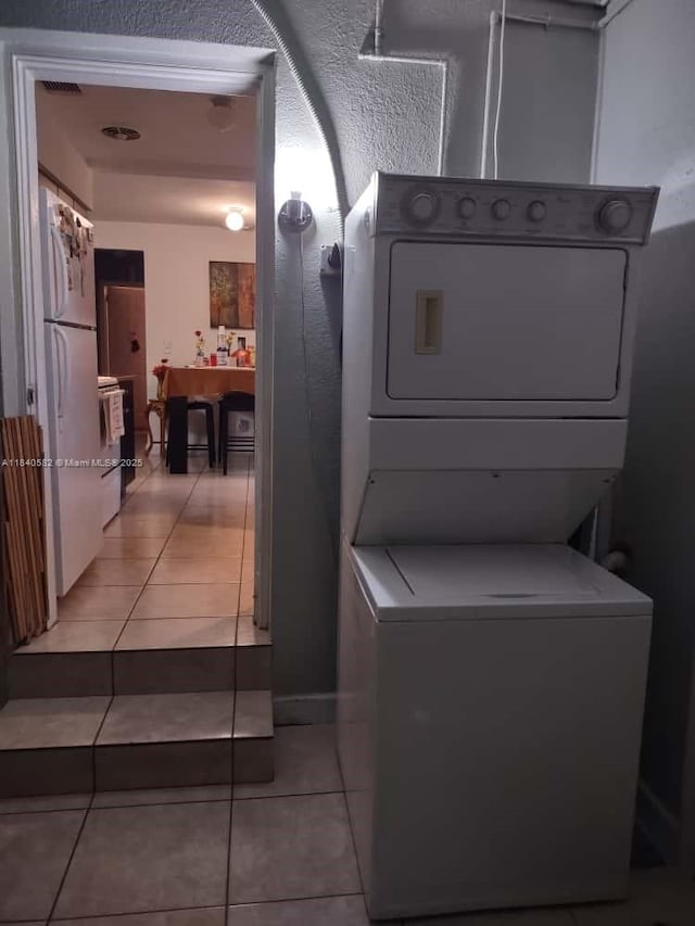 2506 Mayo St, Hollywood, FL 33020 - laundry area featuring stacked washer and clothes dryer and light tile patterned floors