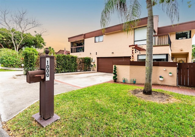 1000 NE 204th Ln Unit D, Miami, FL 33179 - view of front facade featuring stucco siding, driveway, a garage, and a gate