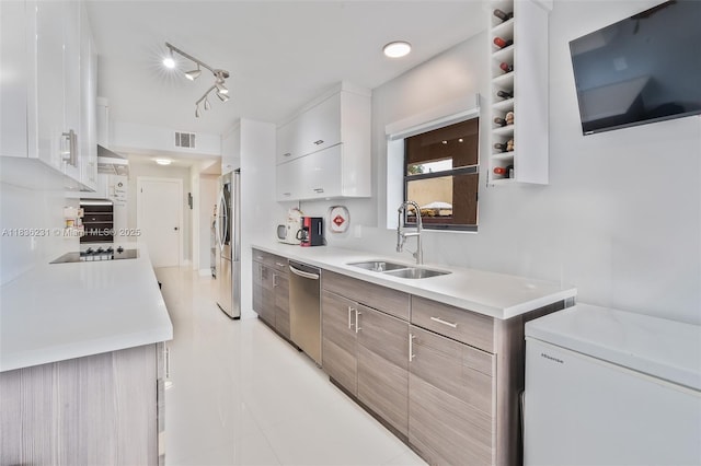 1000 NE 204th Ln Unit D, Miami, FL 33179 - kitchen featuring stainless steel appliances, light countertops, white cabinets, light tile patterned floors, and modern cabinets