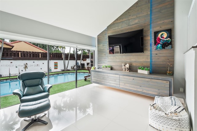 1000 NE 204th Ln Unit D, Miami, FL 33179 - living room featuring wooden walls and high vaulted ceiling