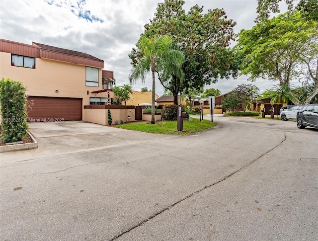 1000 NE 204th Ln Unit D, Miami, FL 33179 - view of front facade with stucco siding, driveway, and an attached garage