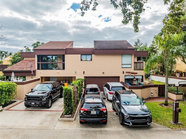 1000 NE 204th Ln Unit D, Miami, FL 33179 - view of front facade with a garage, driveway, and stucco siding