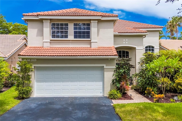 1204 Bayview Cir, Weston, FL 33326 - mediterranean / spanish home with driveway, an attached garage, and a tile roof
