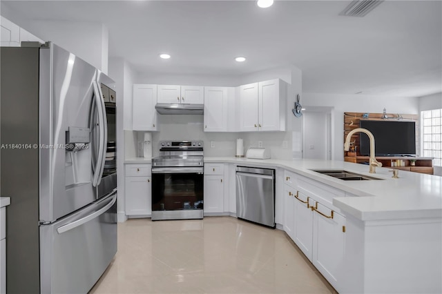 1204 Bayview Cir, Weston, FL 33326 - kitchen featuring appliances with stainless steel finishes, a peninsula, light countertops, white cabinetry, and recessed lighting