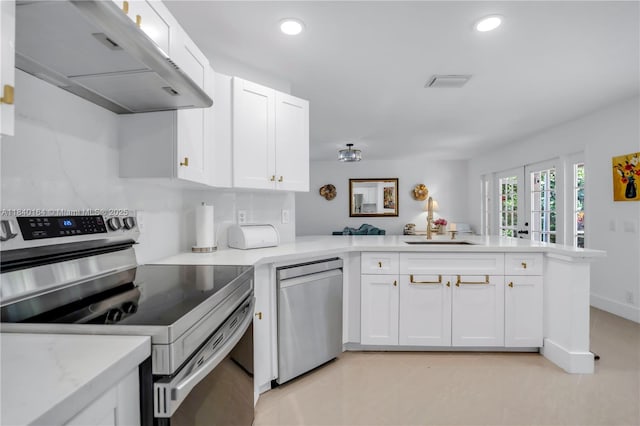 1204 Bayview Cir, Weston, FL 33326 - kitchen featuring stainless steel appliances, a peninsula, extractor fan, light countertops, and white cabinets