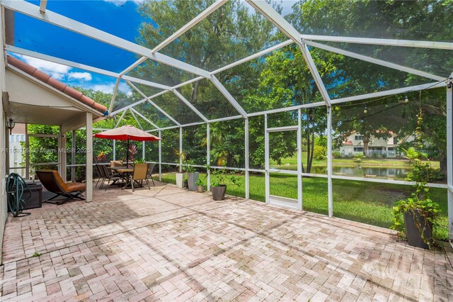 1204 Bayview Cir, Weston, FL 33326 - view of patio / terrace featuring a water view, a lanai, and outdoor dining area
