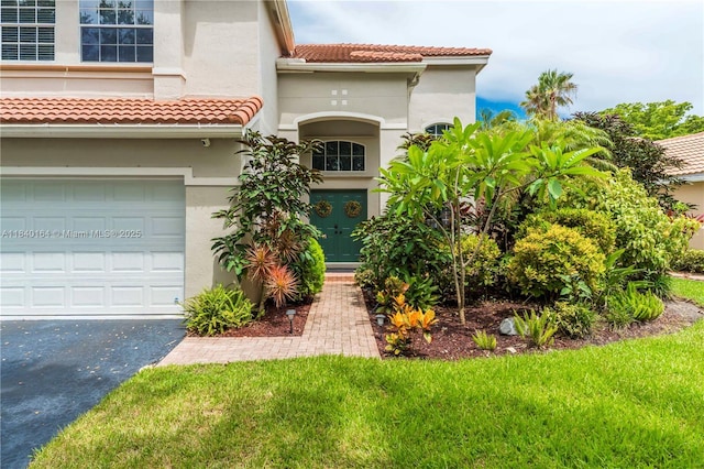 1204 Bayview Cir, Weston, FL 33326 - mediterranean / spanish-style home with stucco siding, a tiled roof, a garage, asphalt driveway, and a front lawn
