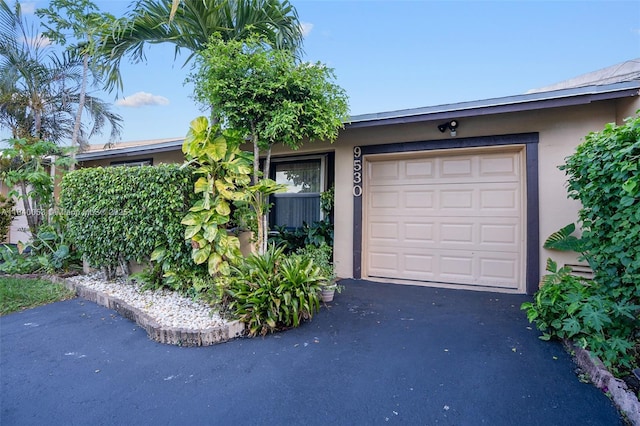 9530 W Daffodil Ln, Miramar, FL 33025 - garage featuring asphalt driveway