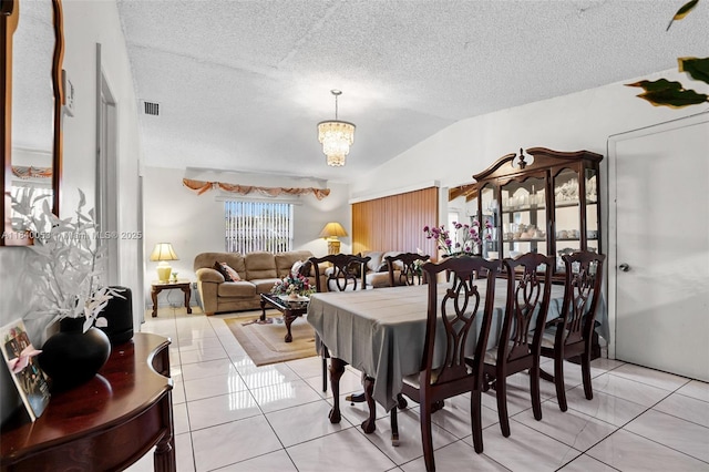 9530 W Daffodil Ln, Miramar, FL 33025 - dining area featuring light tile patterned floors, a chandelier, a textured ceiling, and vaulted ceiling