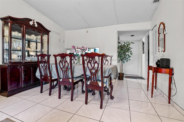 9530 W Daffodil Ln, Miramar, FL 33025 - dining area with light tile patterned flooring and a textured ceiling