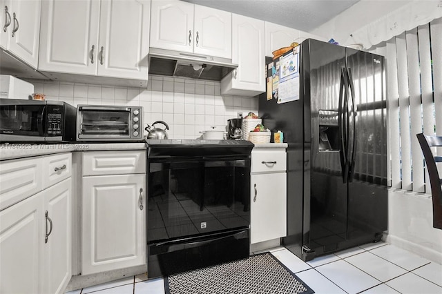 9530 W Daffodil Ln, Miramar, FL 33025 - kitchen featuring black appliances, white cabinetry, premium range hood, and light tile patterned flooring