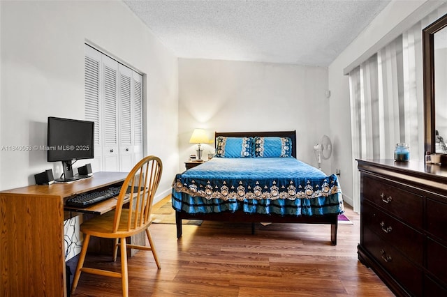9530 W Daffodil Ln, Miramar, FL 33025 - bedroom featuring wood finished floors, a textured ceiling, a closet, and an office area