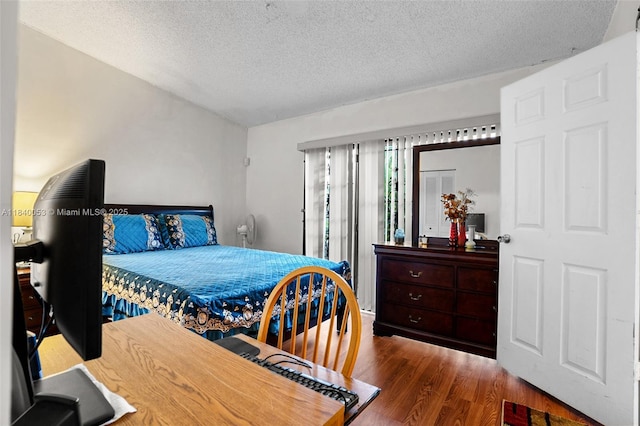 9530 W Daffodil Ln, Miramar, FL 33025 - bedroom featuring wood finished floors and a textured ceiling
