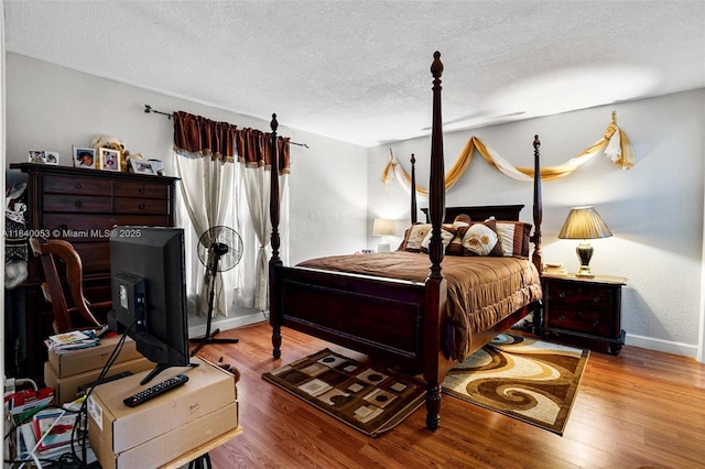 9530 W Daffodil Ln, Miramar, FL 33025 - bedroom featuring a textured ceiling and wood finished floors