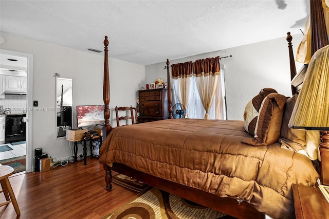 9530 W Daffodil Ln, Miramar, FL 33025 - bedroom with wood finished floors and a textured ceiling