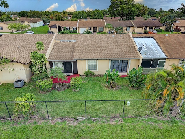 9530 W Daffodil Ln, Miramar, FL 33025 - single story home with a shingled roof, stucco siding, a residential view, and a fenced backyard