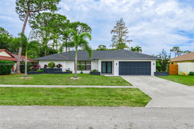 13526 Jonquil Pl, Wellington, FL 33414 - view of front of home featuring stucco siding, a garage, and driveway
