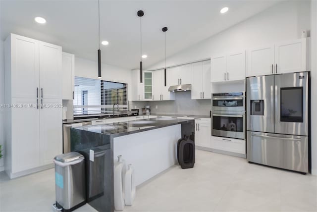 13526 Jonquil Pl, Wellington, FL 33414 - kitchen with stainless steel appliances, tasteful backsplash, white cabinets, lofted ceiling, and a center island