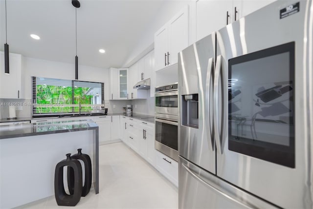 13526 Jonquil Pl, Wellington, FL 33414 - kitchen with appliances with stainless steel finishes, glass insert cabinets, white cabinetry, recessed lighting, and decorative light fixtures