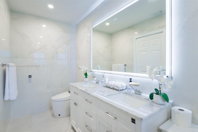 13526 Jonquil Pl, Wellington, FL 33414 - bathroom with double vanity, tile walls, tile patterned floors, and recessed lighting