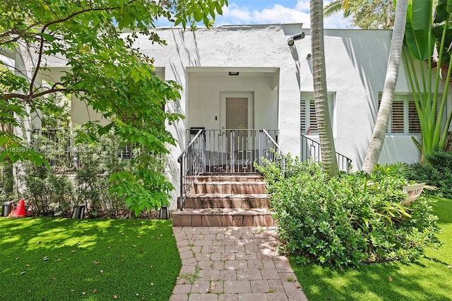 2511 Tequesta Ln, Coconut Grove, FL 33133 - entrance to property with stucco siding and a lawn