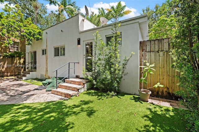 2511 Tequesta Ln, Coconut Grove, FL 33133 - back of property with stucco siding and a patio