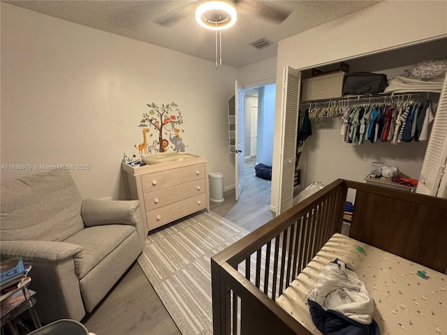 14972 SW 50th Ct, Davie, FL 33331 - bedroom with wood finished floors, a closet, a textured ceiling, and ceiling fan