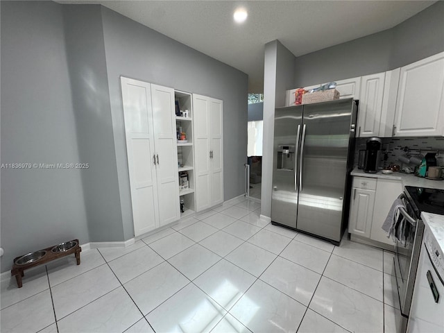 14972 SW 50th Ct, Davie, FL 33331 - kitchen featuring appliances with stainless steel finishes, light countertops, white cabinetry, backsplash, and open shelves