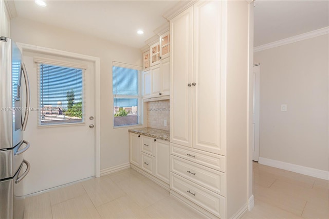 200 NE 14th Ave Unit 524, Hallandale Beach, FL 33009 - kitchen with stainless steel fridge with ice dispenser, backsplash, light stone counters, light tile patterned floors, and glass insert cabinets