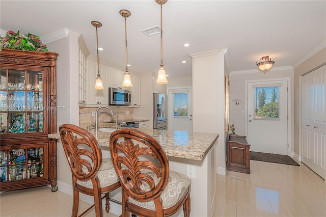 200 NE 14th Ave Unit 524, Hallandale Beach, FL 33009 - kitchen with decorative backsplash, stainless steel appliances, light stone counters, a peninsula, and hanging light fixtures