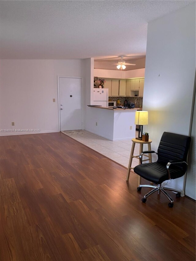 10407 E Clairmont Cir Unit 210, Tamarac, FL 33321 - living room with light wood finished floors and ceiling fan
