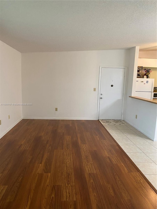 10407 E Clairmont Cir Unit 210, Tamarac, FL 33321 - spare room featuring wood finished floors and a textured ceiling