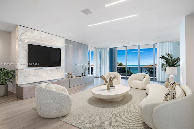 5959 Collins Ave Unit 705, Miami Beach, FL 33140 - living area featuring wood finished floors and floor to ceiling windows