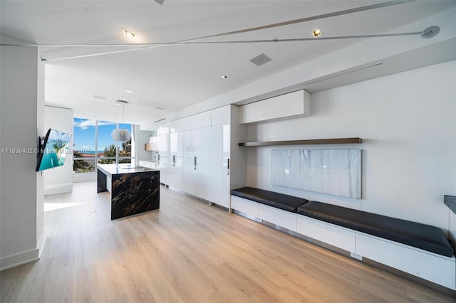 5959 Collins Ave Unit 705, Miami Beach, FL 33140 - kitchen with white cabinetry, modern cabinets, light wood finished floors, a center island, and pendant lighting