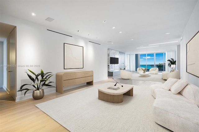 5959 Collins Ave Unit 705, Miami Beach, FL 33140 - living room featuring light wood-type flooring and recessed lighting