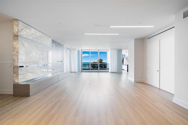 5959 Collins Ave Unit 705, Miami Beach, FL 33140 - unfurnished living room featuring wood finished floors and baseboards