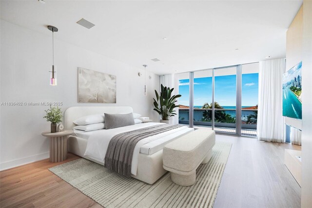 5959 Collins Ave Unit 705, Miami Beach, FL 33140 - bedroom featuring wood finished floors, a wall of windows, and access to exterior